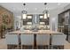 Spacious kitchen features a large island, pendant lighting, mosaic backsplash, and stainless steel appliances at 21642 Emory Oak Pl, Land O Lakes, FL 34637