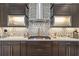Well-appointed kitchen featuring sleek countertops, stainless steel appliances, mosaic backsplash, and ample storage at 21642 Emory Oak Pl, Land O Lakes, FL 34637