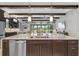 Open-concept kitchen with a large island, stainless steel appliances, and views of the outdoor living area at 21642 Emory Oak Pl, Land O Lakes, FL 34637