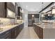 Modern kitchen design boasting a spacious island, sleek countertops, designer backsplash, and stainless appliances at 21642 Emory Oak Pl, Land O Lakes, FL 34637