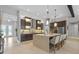 Expansive kitchen featuring a large island with seating, custom cabinetry and stainless steel appliances at 21642 Emory Oak Pl, Land O Lakes, FL 34637