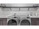 Bright laundry room with modern washer and dryer, countertops, and ample space for cleaning and organization at 21642 Emory Oak Pl, Land O Lakes, FL 34637