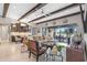 Open concept living area with beamed ceilings, wet bar, and view of outdoor space at 21642 Emory Oak Pl, Land O Lakes, FL 34637