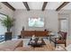 Bright living room with beamed ceilings, entertainment center and comfortable seating area at 21642 Emory Oak Pl, Land O Lakes, FL 34637