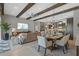 Open concept living space featuring wood beams, dining area and modern furnishings at 21642 Emory Oak Pl, Land O Lakes, FL 34637