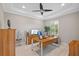 Well-lit home office with built-in cabinets, a ceiling fan, and plantation shutters at 21642 Emory Oak Pl, Land O Lakes, FL 34637