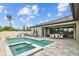 Enjoy outdoor entertaining with this backyard pool, spa, outdoor kitchen, patio, and dining area at 21642 Emory Oak Pl, Land O Lakes, FL 34637