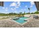 Stunning backyard pool features lake views, a spa, and an outdoor kitchen perfect for entertaining at 21642 Emory Oak Pl, Land O Lakes, FL 34637