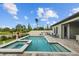 Beautiful backyard pool with spa, brick patio, outdoor kitchen, and seating area is ideal for relaxing at 21642 Emory Oak Pl, Land O Lakes, FL 34637