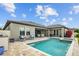 Lovely backyard pool and patio, including seating and dining areas, enhance outdoor living at 21642 Emory Oak Pl, Land O Lakes, FL 34637