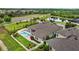 Attractive aerial view of a home featuring a private pool, beautiful landscaping, and a charming outdoor living space at 21642 Emory Oak Pl, Land O Lakes, FL 34637
