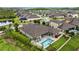 Beautiful aerial view of the home with a sparkling pool, jacuzzi, and manicured backyard, perfect for outdoor entertaining at 21642 Emory Oak Pl, Land O Lakes, FL 34637