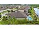 Stunning aerial view of the property, showcasing the luxurious pool, manicured landscaping, and peaceful lake view at 21642 Emory Oak Pl, Land O Lakes, FL 34637