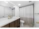 Bright bathroom featuring modern vanity, updated sink, and shower with new fixtures at 2233 Springwood W Cir, Clearwater, FL 33763