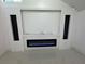 Modern living room features an electric fireplace with a sleek white mantle and marble-like black accent at 2233 Springwood W Cir, Clearwater, FL 33763