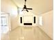 Spacious living room with high ceilings, tile flooring, and a modern fireplace at 2233 Springwood W Cir, Clearwater, FL 33763