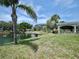 Lush green backyard overlooking a pond and a view of the condos in the distance at 2333 Feather Sound Dr # B309, Clearwater, FL 33762