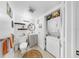 Updated bathroom with vanity, stacked washer/dryer, and decoratively appointed shelves at 2333 Feather Sound Dr # B309, Clearwater, FL 33762