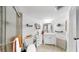Bright bathroom with shower, stylish vanity, decorative shelves, and tile floor at 2333 Feather Sound Dr # B309, Clearwater, FL 33762