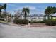 Entrance to Crystal Bay at Feather Sound with lush landscaping and serene water views at 2333 Feather Sound Dr # B309, Clearwater, FL 33762