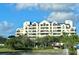Multi-level building with many windows overlooking landscaping and a water feature on a partly cloudy day at 2333 Feather Sound Dr # B309, Clearwater, FL 33762
