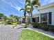 Charming single-story home featuring a well-manicured lawn, lush landscaping, and a welcoming entrance at 2333 Feather Sound Dr # B309, Clearwater, FL 33762
