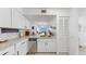 Bright kitchen with granite countertops, stainless steel appliances, and white cabinets at 2333 Feather Sound Dr # B309, Clearwater, FL 33762