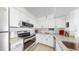 Bright kitchen with granite countertops and white cabinets and stainless steel appliances at 2333 Feather Sound Dr # B309, Clearwater, FL 33762