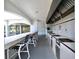The covered outdoor kitchen features bar seating and built-in grills at 2333 Feather Sound Dr # B309, Clearwater, FL 33762