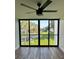 Balcony with ceiling fan, view of lake, green space, and trees at 2424 W Tampa Bay Blvd # 203, Tampa, FL 33607