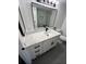 Bathroom with a large vanity, a mirror, updated lighting, and a tiled walk-in shower at 2424 W Tampa Bay Blvd # 203, Tampa, FL 33607