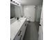 Bathroom with a large vanity, a mirror, updated lighting, and a tiled walk-in shower at 2424 W Tampa Bay Blvd # 203, Tampa, FL 33607