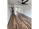 Bright bedroom with wood floors, ceiling fan, closet with mirrored doors, and white walls at 2424 W Tampa Bay Blvd # 203, Tampa, FL 33607