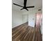 Well-lit bedroom featuring wood floors, closet with mirrored doors, and a ceiling fan at 2424 W Tampa Bay Blvd # 203, Tampa, FL 33607