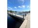 Wooden dock with a view of a calm waterway and docked boats under a partly cloudy sky at 2424 W Tampa Bay Blvd # 203, Tampa, FL 33607
