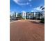 Condo building features a brick entry with parking and patriotic flags waving in the wind at 2424 W Tampa Bay Blvd # 203, Tampa, FL 33607