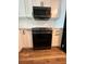 Kitchen features updated appliances with black hardware and stylish white cabinets at 2424 W Tampa Bay Blvd # 203, Tampa, FL 33607