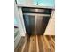 New stainless steel dishwasher installed beneath updated countertops and white cabinets in kitchen at 2424 W Tampa Bay Blvd # 203, Tampa, FL 33607
