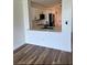 Modern white kitchen featuring countertops, a breakfast bar, updated appliances and wood-look flooring at 2424 W Tampa Bay Blvd # 203, Tampa, FL 33607