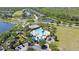 Aerial view of community pool, playground, and amenities surrounded by scenic lakes and greenery at 2903 Cypress Bowl Rd, Lutz, FL 33558