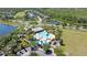 Aerial view of community pool, playground, and amenities surrounded by scenic lakes and greenery at 2903 Cypress Bowl Rd, Lutz, FL 33558