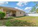 Grassy backyard with patio and covered patio area perfect for outdoor relaxation at 2903 Cypress Bowl Rd, Lutz, FL 33558
