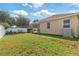 Expansive backyard with patio, outdoor chairs, and well-maintained lawn at 2903 Cypress Bowl Rd, Lutz, FL 33558