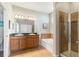 Bathroom featuring double vanity, soaking tub, and glass-enclosed shower at 2903 Cypress Bowl Rd, Lutz, FL 33558