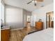 Spacious bedroom with wood floors, ceiling fan, and ample natural light at 2903 Cypress Bowl Rd, Lutz, FL 33558