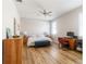 Bedroom features natural light, ceiling fan, desk area, and hardwood floors at 2903 Cypress Bowl Rd, Lutz, FL 33558