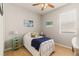 Cozy bedroom with wood floors, artwork, and window offering natural light at 2903 Cypress Bowl Rd, Lutz, FL 33558