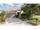 Charming single-Gathering home featuring a two-car garage and mature landscaping at 2903 Cypress Bowl Rd, Lutz, FL 33558