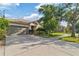 Charming single-story home featuring a well-maintained lawn, mature trees, and a two-car garage at 2903 Cypress Bowl Rd, Lutz, FL 33558