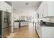 Open-concept kitchen featuring granite countertops, stainless steel appliances and white cabinetry at 2903 Cypress Bowl Rd, Lutz, FL 33558